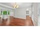 Dining room featuring hardwood floors, lots of natural light, and open to the kitchen at 2895 Shurburne Dr, Alpharetta, GA 30022