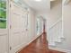 Bright entryway featuring hardwood floors, a white staircase, and natural light at 2895 Shurburne Dr, Alpharetta, GA 30022