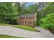 Attractive brick home with black shutters on a spacious lot with mature trees and landscaping at 2895 Shurburne Dr, Alpharetta, GA 30022