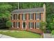 Traditional brick home with black shutters and a well-maintained lawn and driveway at 2895 Shurburne Dr, Alpharetta, GA 30022
