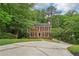 Traditional two-story brick home with black shutters and a spacious driveway at 2895 Shurburne Dr, Alpharetta, GA 30022