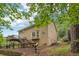 Exterior view showcasing a two-story home with a deck surrounded by trees at 2895 Shurburne Dr, Alpharetta, GA 30022