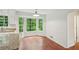 Kitchen nook with hardwood floors, wainscotting detail, and lots of natural light at 2895 Shurburne Dr, Alpharetta, GA 30022