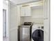 Laundry closet with a stacked washer and dryer unit at 2895 Shurburne Dr, Alpharetta, GA 30022