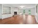 Spacious living room with hardwood floors, built-in shelving, and a cozy fireplace at 2895 Shurburne Dr, Alpharetta, GA 30022