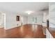 Bright living room featuring hardwood floors, fireplace, and wainscotting detail at 2895 Shurburne Dr, Alpharetta, GA 30022