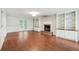 Spacious living room featuring hardwood floors, built-in shelving, and a fireplace at 2895 Shurburne Dr, Alpharetta, GA 30022