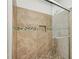Modern shower featuring neutral tiles with glass door, decorative tile accent, and a built-in niche at 2895 Shurburne Dr, Alpharetta, GA 30022