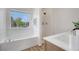 Bright bathroom featuring a bathtub, standing shower and a single sink vanity at 3552 Clear Creek Nw Xing, Kennesaw, GA 30144