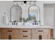 Bathroom featuring a double vanity with sleek black fixtures, bright lighting and arched mirrors at 3552 Clear Creek Nw Xing, Kennesaw, GA 30144