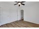 Bedroom featuring wood-look floors, white walls, a ceiling fan, and multiple doors at 3552 Clear Creek Nw Xing, Kennesaw, GA 30144