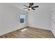 Bedroom featuring wood-look floors, a ceiling fan, a window, and white walls at 3552 Clear Creek Nw Xing, Kennesaw, GA 30144