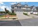 Townhome with two-car garage, landscaped lawn, and neighborhood street view at 3552 Clear Creek Nw Xing, Kennesaw, GA 30144