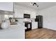 Modern kitchen featuring white cabinets, black appliances, and wood flooring, perfect for culinary enthusiasts at 3552 Clear Creek Nw Xing, Kennesaw, GA 30144