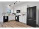 Modern kitchen with white cabinets, black appliances, wood floor, and plenty of counter space at 3552 Clear Creek Nw Xing, Kennesaw, GA 30144