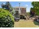 Brick home featuring a deck, trampoline, and landscaped backyard with tiered stone retaining walls at 4675 Lakeway Pl, Alpharetta, GA 30005