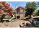 Landscaped backyard features a stone patio with fire pit, wooden deck, and lush greenery at 4675 Lakeway Pl, Alpharetta, GA 30005