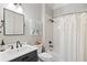 This bathroom features a shower and tub, along with a nice black vanity at 4675 Lakeway Pl, Alpharetta, GA 30005