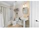 Bathroom with white tile, pedestal sink, and shower-tub combination at 4675 Lakeway Pl, Alpharetta, GA 30005