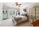 Cozy bedroom with neutral walls and carpet, decorative wrought iron accents, and a ceiling fan at 4675 Lakeway Pl, Alpharetta, GA 30005