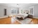 Bedroom with hardwood floors, white walls, white rug, a ceiling fan, and two windows at 4675 Lakeway Pl, Alpharetta, GA 30005