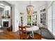 Cozy dining area with large windows, a cushioned bench, a round table, and a decorative chandelier creating an inviting space at 4675 Lakeway Pl, Alpharetta, GA 30005