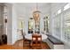 Bright breakfast nook with round table, bench seating, and large windows providing ample natural light and wooded views at 4675 Lakeway Pl, Alpharetta, GA 30005