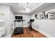 Finished basement exercise room with modern workout equipment and recessed lighting at 4675 Lakeway Pl, Alpharetta, GA 30005