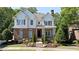 Charming two-story home with brick and stone accents, beautiful landscaping, and a welcoming front porch at 4675 Lakeway Pl, Alpharetta, GA 30005
