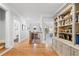 Hallway featuring hardwood floors, a staircase, and built-in shelving at 4675 Lakeway Pl, Alpharetta, GA 30005