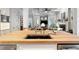 Kitchen island with butcher block top, stainless steel appliances, hardwood floors, and open layout to living area at 4675 Lakeway Pl, Alpharetta, GA 30005