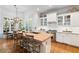 Modern kitchen featuring an island with seating, stainless appliances, and ample natural light at 4675 Lakeway Pl, Alpharetta, GA 30005