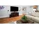 Well-lit living room with hardwood floors, cozy seating and views to an adjacent hall at 4675 Lakeway Pl, Alpharetta, GA 30005