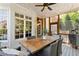 Covered back porch has an outdoor dining area with an elegant table setting with a view to the woods at 4675 Lakeway Pl, Alpharetta, GA 30005