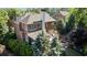 Home featuring brick construction, covered porch, and landscaped backyard with stone retaining walls at 4675 Lakeway Pl, Alpharetta, GA 30005