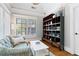 Bright sitting room features hardwood floors, bright windows and built-in shelves at 4675 Lakeway Pl, Alpharetta, GA 30005