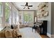 Bright sunroom featuring hardwood floors, lots of windows, and a piano at 4675 Lakeway Pl, Alpharetta, GA 30005