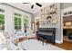 Bright sunroom featuring lots of windows and a piano with shelving at 4675 Lakeway Pl, Alpharetta, GA 30005