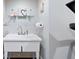 White utility sink with stainless steel faucet and basic necessities on a glass shelf at 4675 Lakeway Pl, Alpharetta, GA 30005