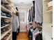 Spacious walk-in closet with custom shelving, hanging racks and natural light at 4675 Lakeway Pl, Alpharetta, GA 30005