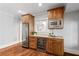 Charming wet bar with custom wooden cabinets, microwave, and dual beverage refrigerators at 4675 Lakeway Pl, Alpharetta, GA 30005