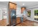 Charming wet bar with custom wooden cabinets, beverage refrigerator and wine cooler at 4675 Lakeway Pl, Alpharetta, GA 30005