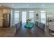 Dining area with stainless steel refrigerator and abundant light and views into living area at 107 Iveybrooke Ln # 58, Alpharetta, GA 30009