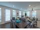 Well-lit dining area showcasing modern furnishings, large windows and views into the living area at 107 Iveybrooke Ln # 58, Alpharetta, GA 30009