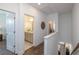 Hallway featuring wood floors and entrances to a bathroom and other rooms in a brightly lit home at 107 Iveybrooke Ln # 58, Alpharetta, GA 30009