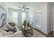 Cozy living room features large windows, natural light, a ceiling fan, and plush seating at 107 Iveybrooke Ln # 58, Alpharetta, GA 30009