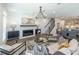 Open-concept living room with wood floors, fireplace, and seamless flow to the kitchen and dining area at 107 Iveybrooke Ln # 58, Alpharetta, GA 30009