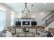 Inviting living room with fireplace, hardwood floors, and an open staircase and access to the kitchen at 107 Iveybrooke Ln # 58, Alpharetta, GA 30009