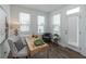 Bright home office features wood desk, chair, and natural light from large windows with sleek blinds at 107 Iveybrooke Ln # 58, Alpharetta, GA 30009
