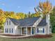 Charming home with stone accents, blue shutters, professionally landscaped lawn, and chimney at 124 Williams Blf, Mcdonough, GA 30252